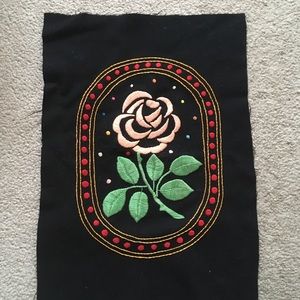Rose embroidered on black felt fabric.pillow cover